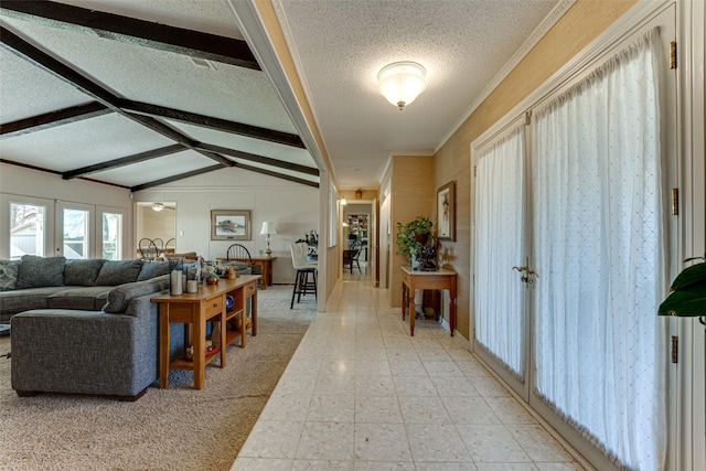 interior space featuring vaulted ceiling with beams and a textured ceiling