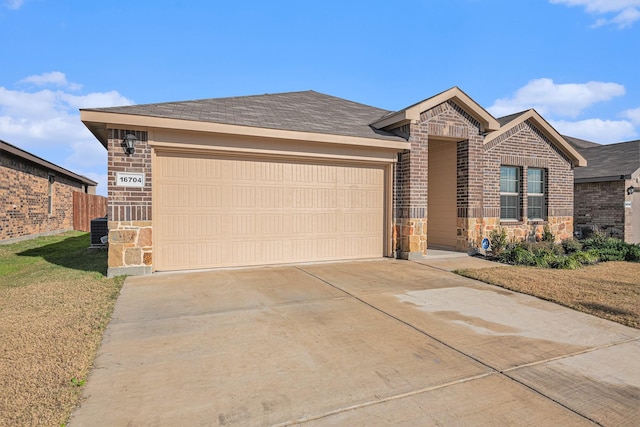 ranch-style home featuring central AC and a garage