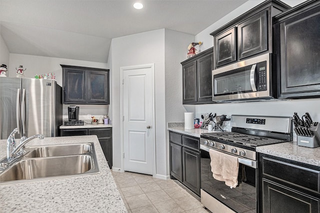 kitchen with sink, stainless steel appliances, and light tile patterned flooring