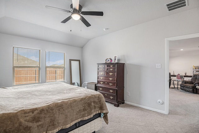 carpeted bedroom with ceiling fan and vaulted ceiling