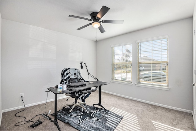 carpeted office featuring ceiling fan