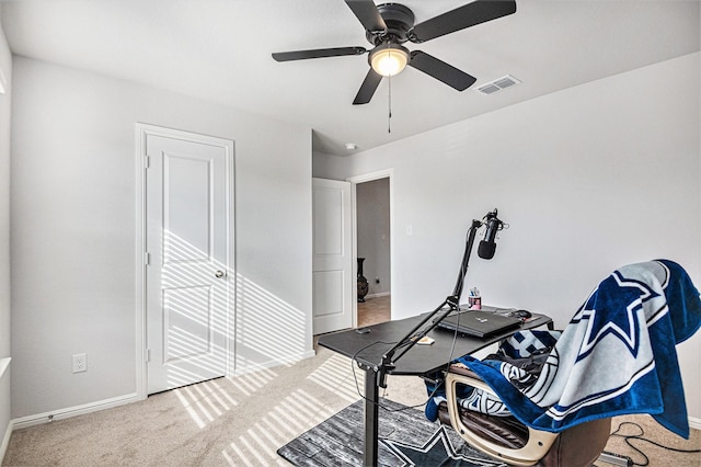 office space featuring ceiling fan and carpet