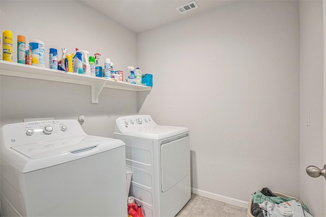 clothes washing area with washer and clothes dryer