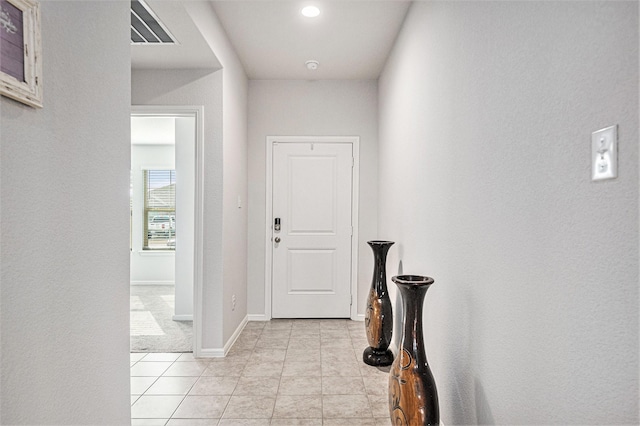 hall featuring light tile patterned floors