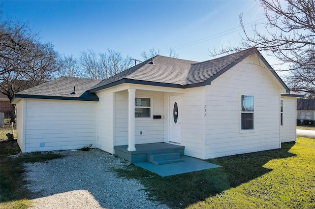 rear view of house featuring a yard