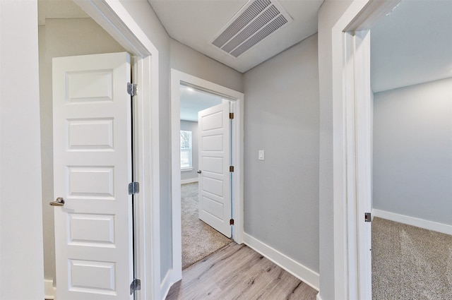 hallway with light colored carpet