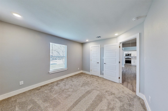 unfurnished bedroom with carpet floors