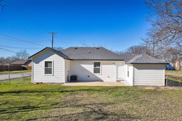 rear view of house with central air condition unit, a patio area, and a lawn