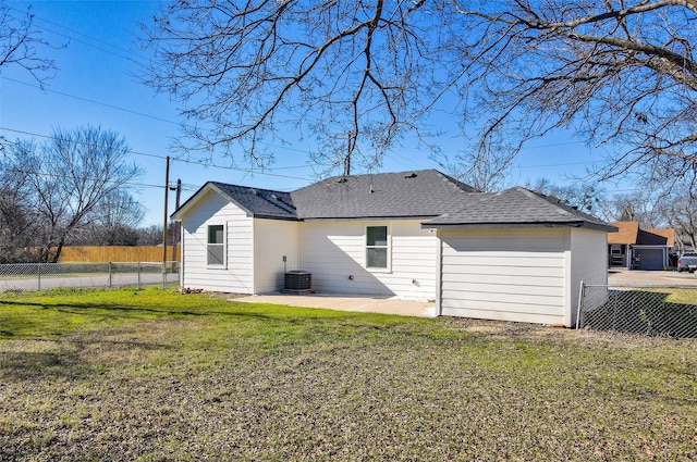 back of property featuring a lawn, central air condition unit, and a patio