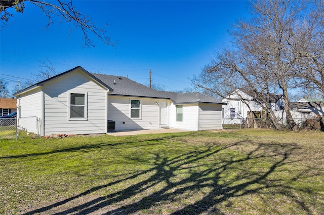 rear view of house featuring a lawn and a patio area