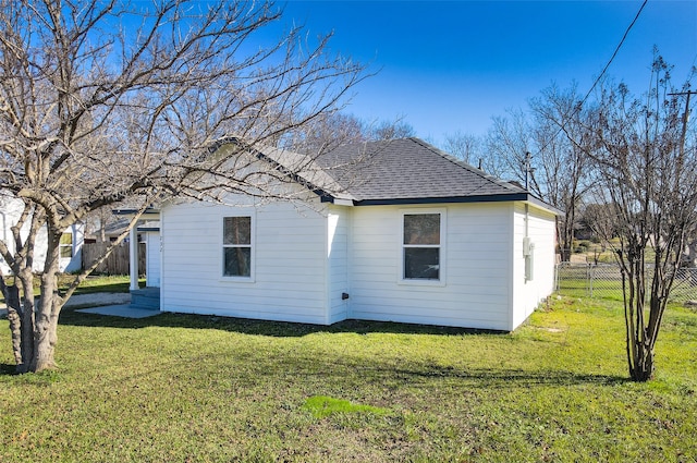 back of house with a lawn