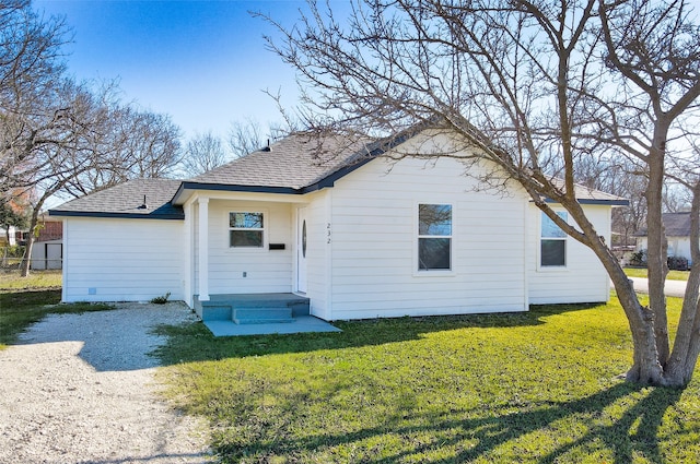 back of property featuring a lawn