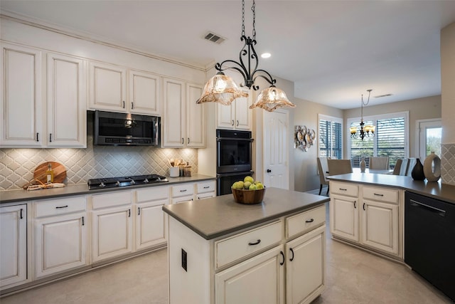 kitchen featuring stainless steel gas stovetop, hanging light fixtures, black dishwasher, and double oven