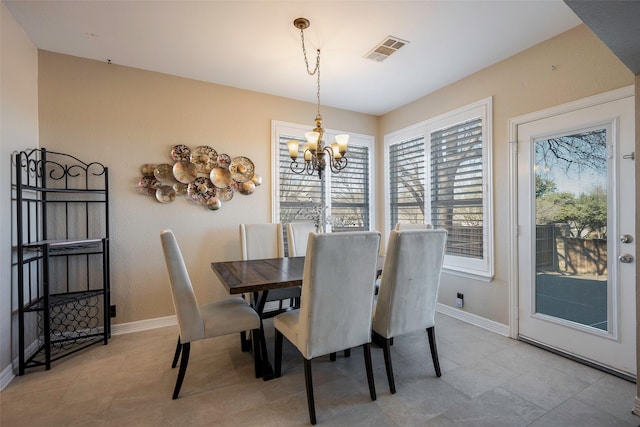 dining area featuring a notable chandelier