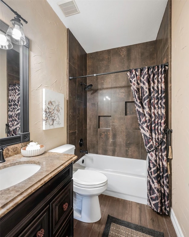 full bathroom with hardwood / wood-style flooring, vanity, shower / bath combination with curtain, and toilet