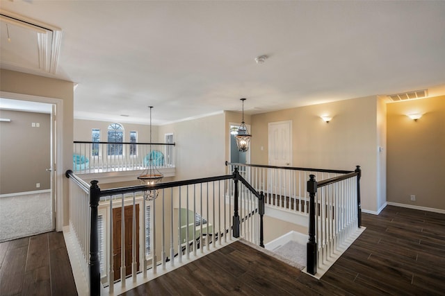 hallway featuring an inviting chandelier and dark hardwood / wood-style floors