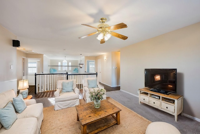 living room with dark carpet and ceiling fan