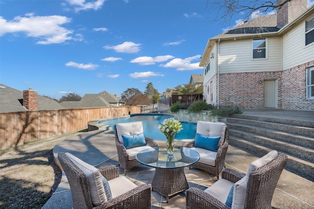 view of patio featuring a fenced in pool and an outdoor living space