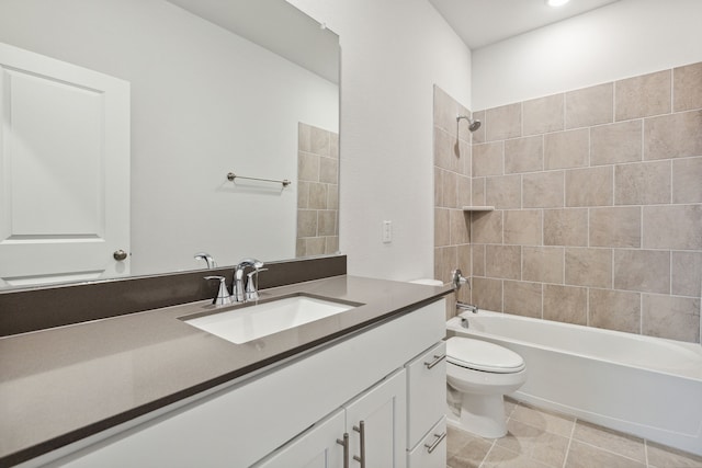 full bathroom featuring tiled shower / bath, vanity, tile patterned floors, and toilet