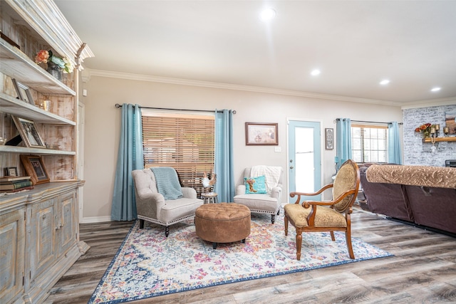 living room with hardwood / wood-style floors and ornamental molding