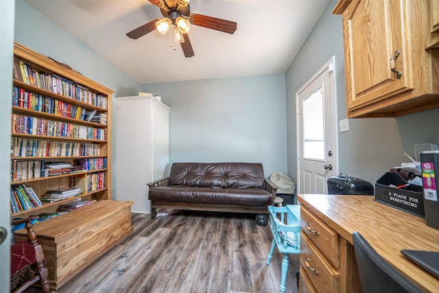 living area featuring dark hardwood / wood-style flooring and ceiling fan