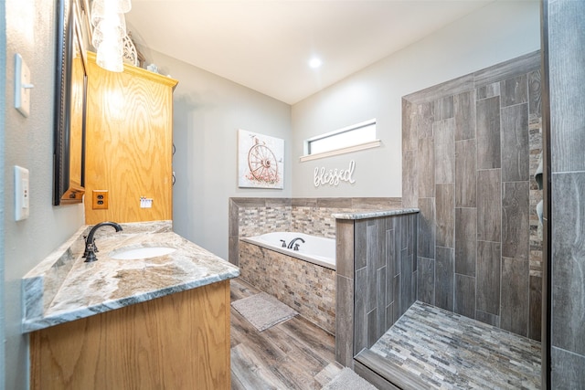 bathroom with vanity, independent shower and bath, and wood-type flooring