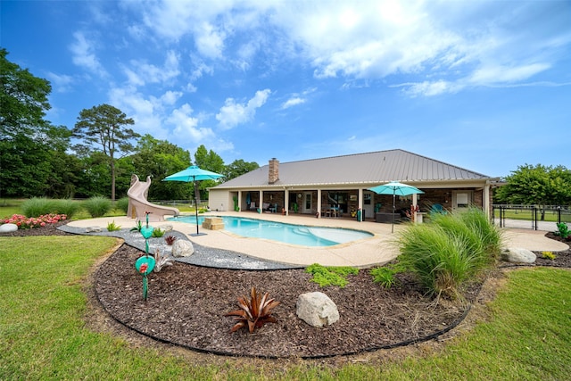 view of pool with a patio area and a water slide