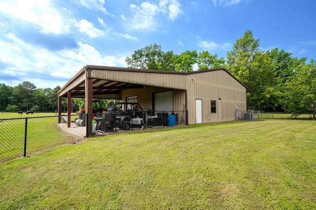 view of outbuilding with central AC unit and a lawn