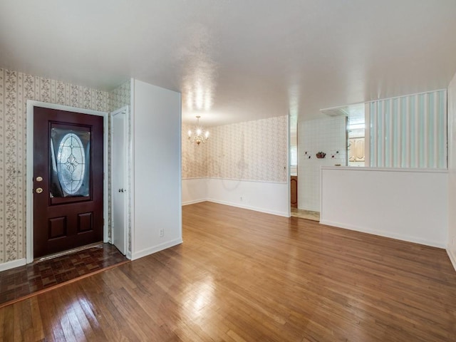 entrance foyer with hardwood / wood-style flooring and a chandelier