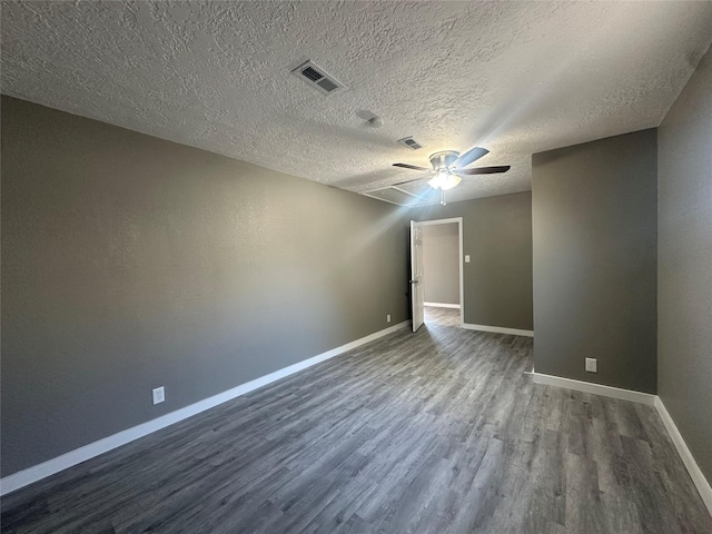 unfurnished room with a textured ceiling and dark hardwood / wood-style flooring