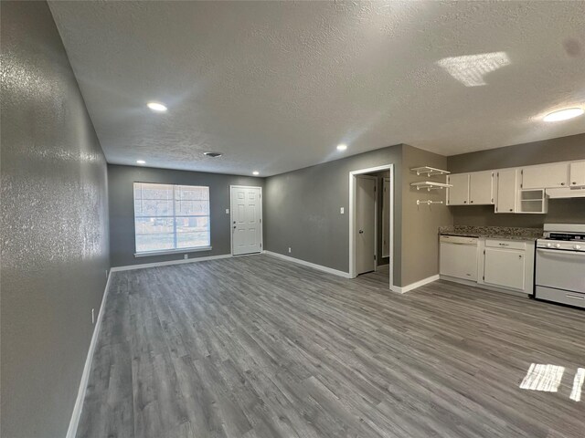 interior space with a textured ceiling and light hardwood / wood-style flooring