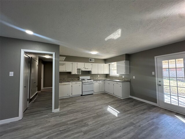 kitchen featuring white cabinets, a textured ceiling, white appliances, and dark hardwood / wood-style floors