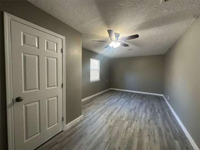 spare room with ceiling fan, hardwood / wood-style floors, and a textured ceiling