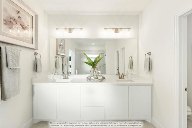 bathroom with vanity, toilet, and a shower with door