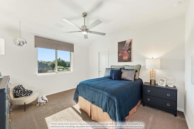 bedroom with ceiling fan, vaulted ceiling, and dark colored carpet