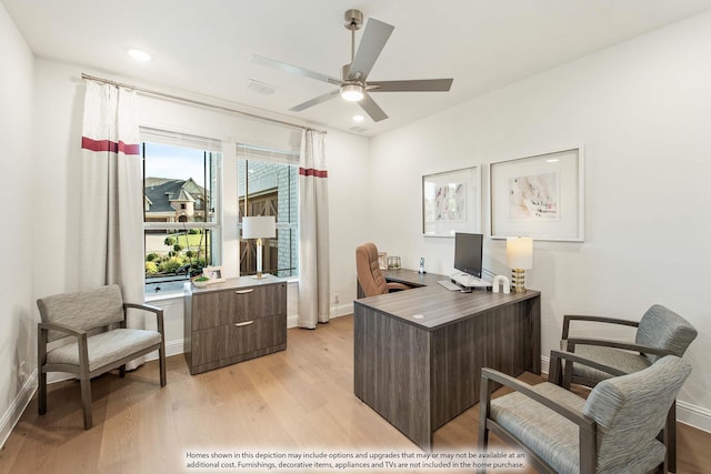 home office with ceiling fan and light wood-type flooring