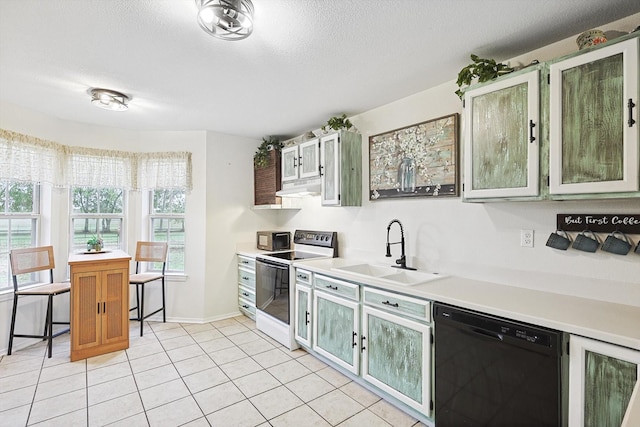 kitchen with sink, a textured ceiling, light tile patterned floors, white electric stove, and dishwasher