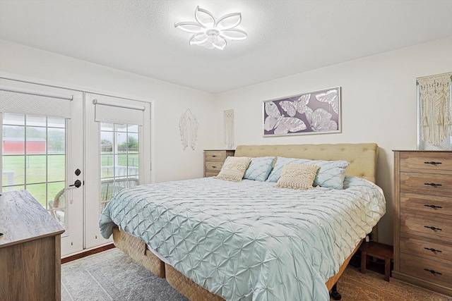 bedroom featuring access to exterior and a textured ceiling