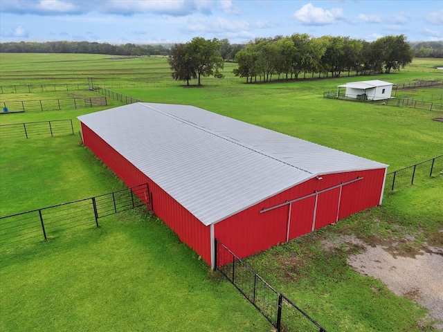 view of outdoor structure with a rural view and a yard