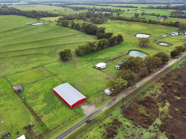 drone / aerial view with a water view and a rural view