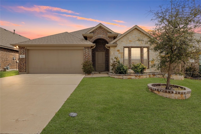 view of front of house featuring a garage and a yard