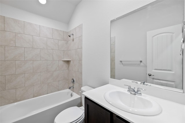 full bathroom with vanity, lofted ceiling, toilet, and tiled shower / bath