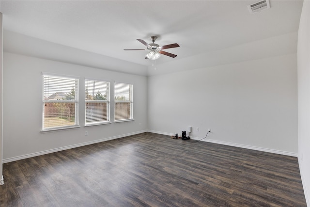 empty room with dark hardwood / wood-style flooring and ceiling fan