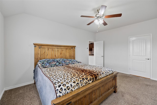 carpeted bedroom with vaulted ceiling and ceiling fan