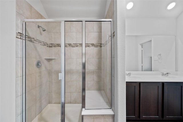 bathroom with vanity and a shower with shower door