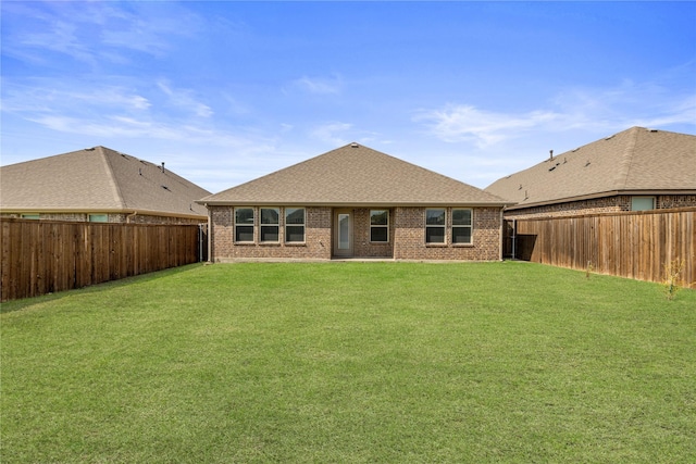 back of house with a lawn