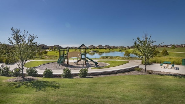 view of playground featuring a water view and a lawn