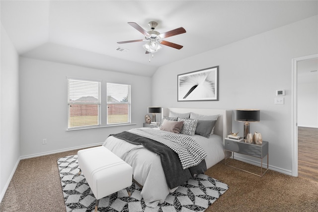 bedroom with vaulted ceiling, ceiling fan, and carpet flooring