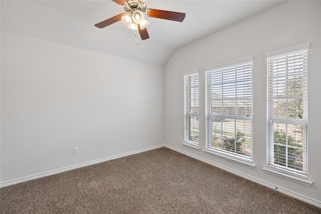 carpeted empty room with ceiling fan, a healthy amount of sunlight, and vaulted ceiling