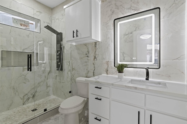 bathroom featuring toilet, marble finish floor, a marble finish shower, and vanity